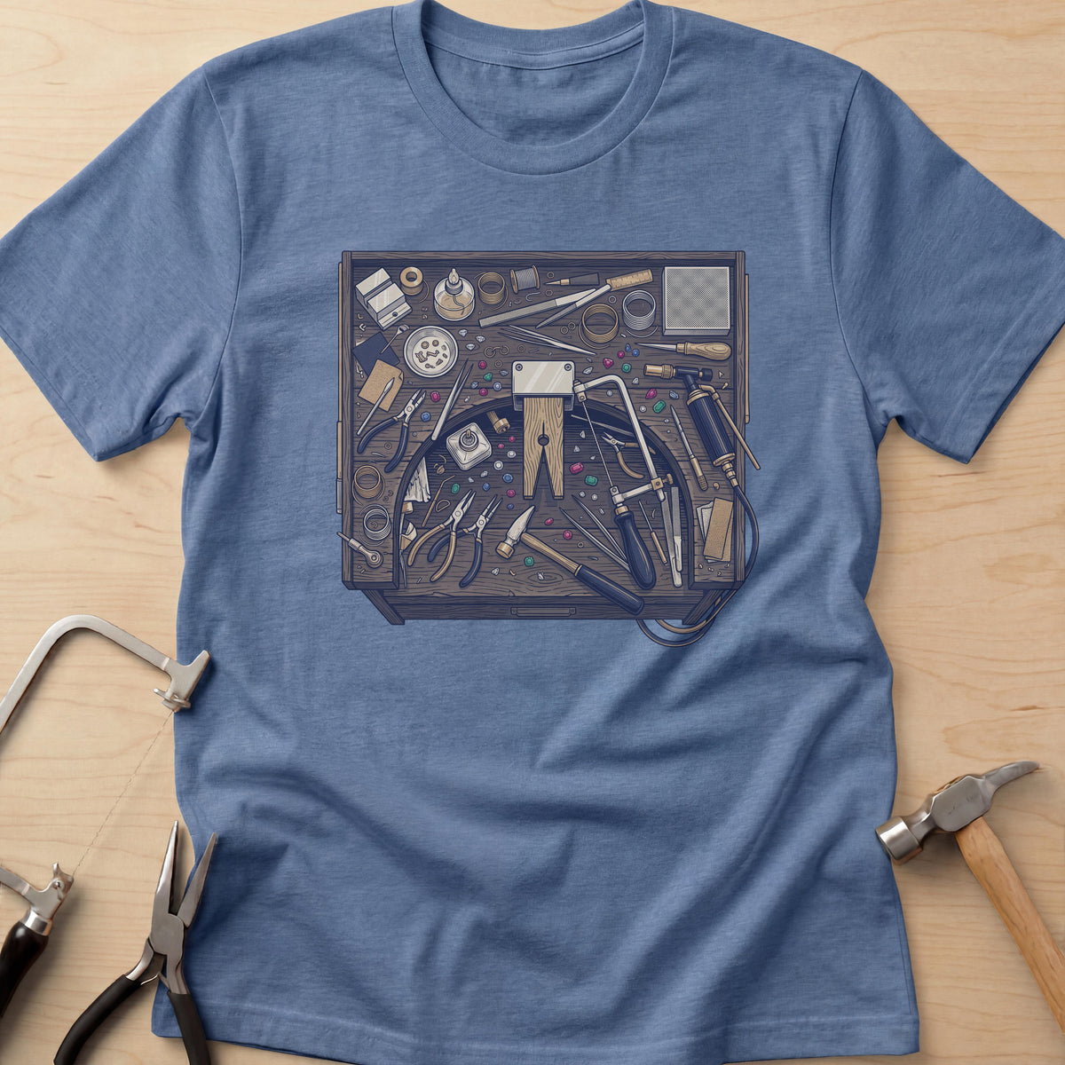 Jeweler's Bench jewelry maker t-shirt in Heather Indigo, flat lay with jeweler's tools