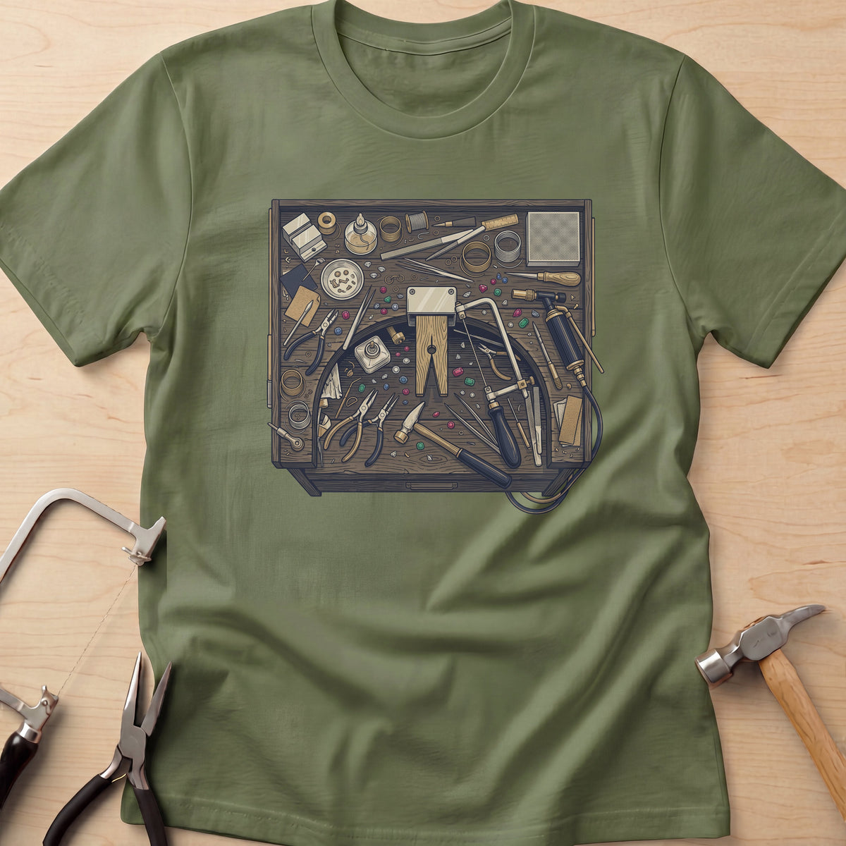 Jeweler's Bench jewelry maker t-shirt in Sage, flat lay with jeweler's tools