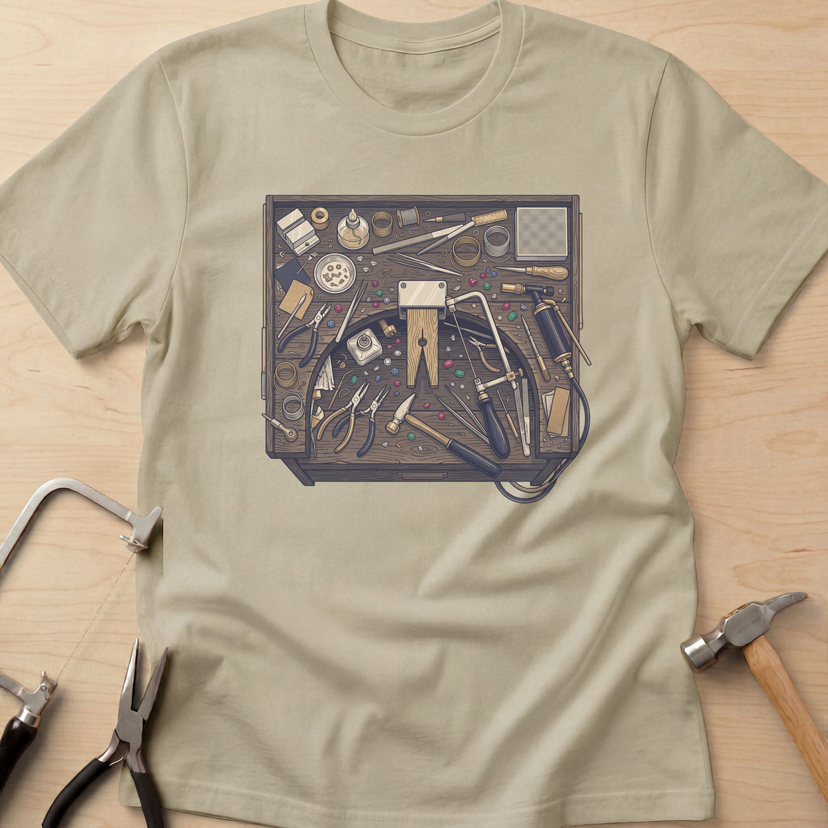 Jeweler's Bench jewelry maker t-shirt in Sand, flat lay with jeweler's tools