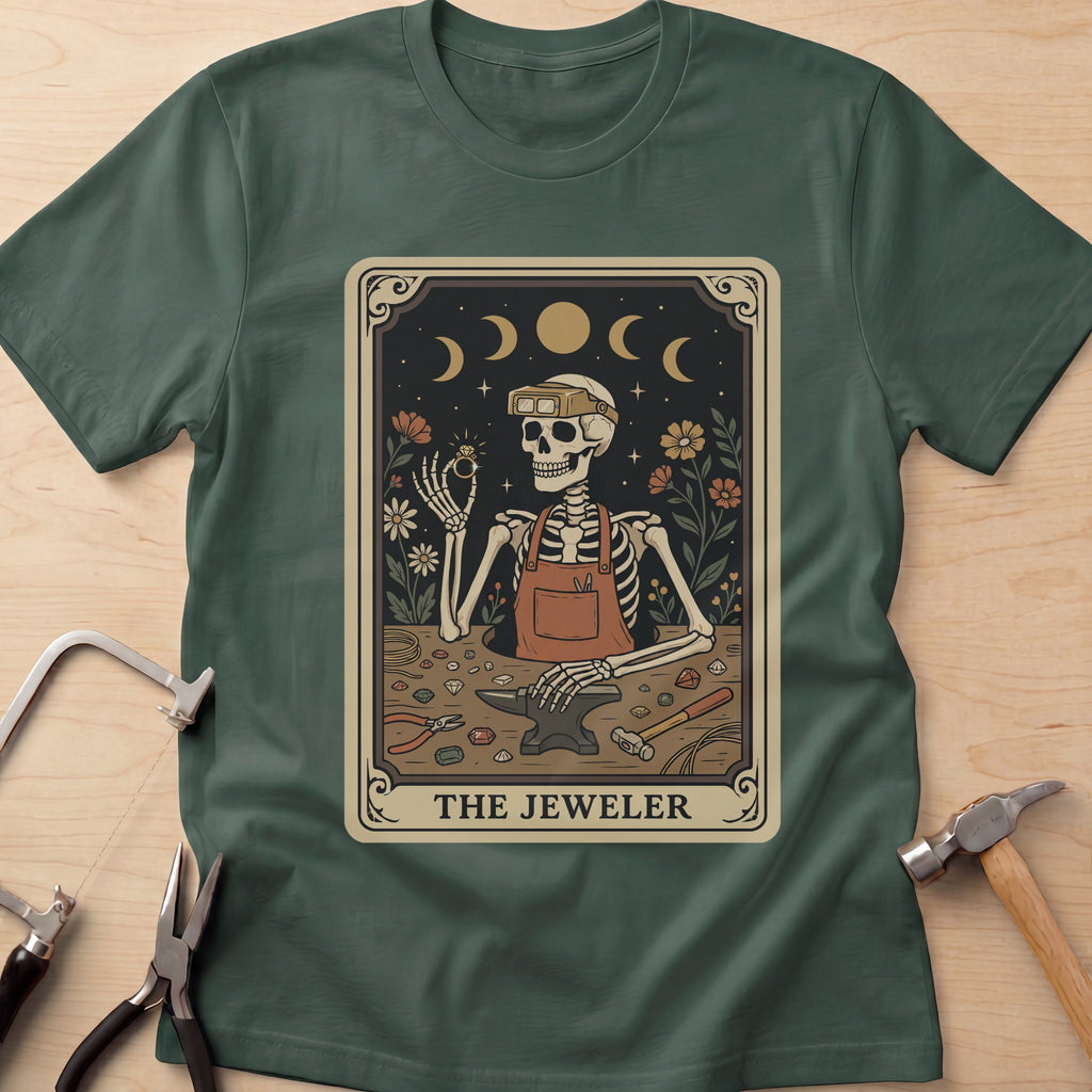The Jeweler Tarot (Daisies) jewelry maker t-shirt in Forest Green, flat lay with jeweler's tools