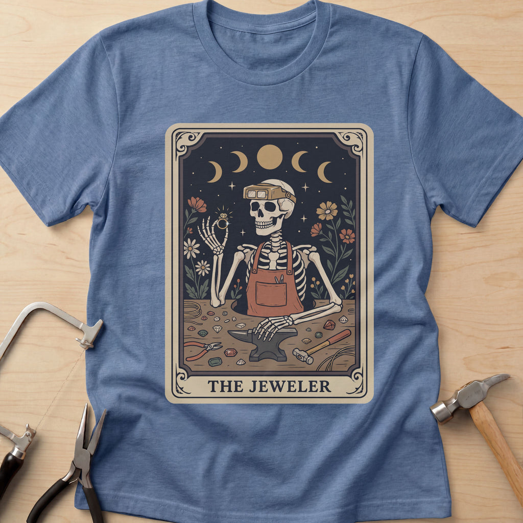 The Jeweler Tarot (Daisies) jewelry maker t-shirt in Heather Indigo, flat lay with jeweler's tools