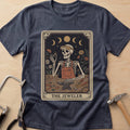 The Jeweler Tarot (Daisies) jewelry maker t-shirt in Heather Navy, flat lay with jeweler's tools