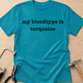 Blood Type: Turquoise rockhound t-shirt in Tropical Blue, flat lay with jeweler's tools