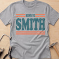 Born to Smith silversmith t-shirt in Sport Grey, flat lay with jeweler's tools