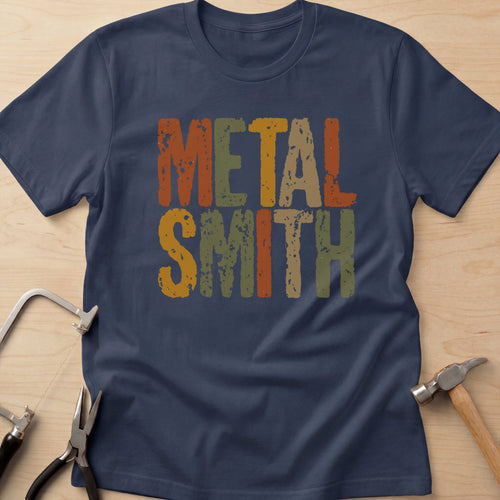 Earthy Metalsmith jewelry maker t-shirt in Navy, flat lay with jeweler's tools